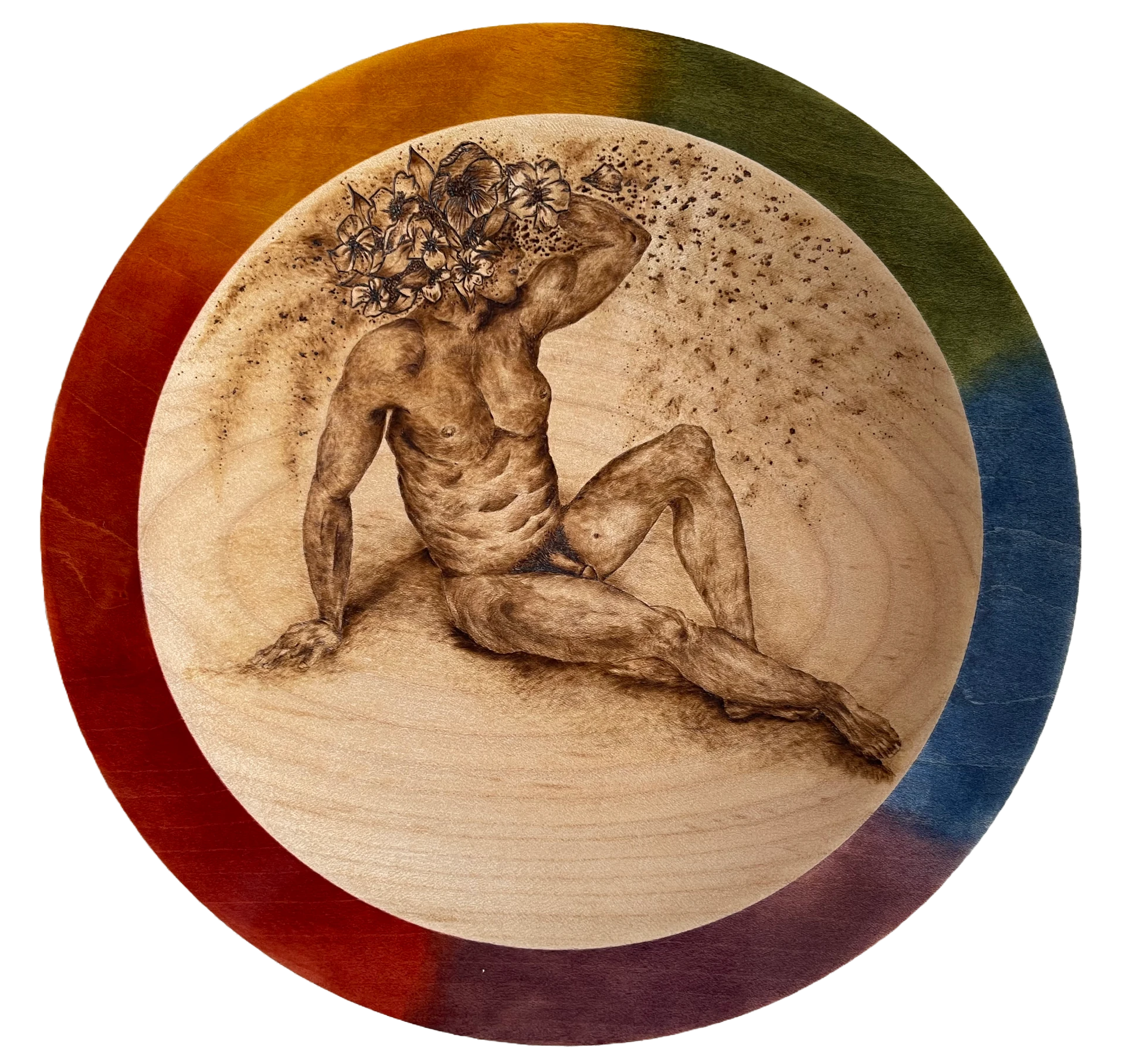 A mediums sized bowl with a nude man covered in flowers drawn in the centre using pyrography and a rainbow effect painted around the rim