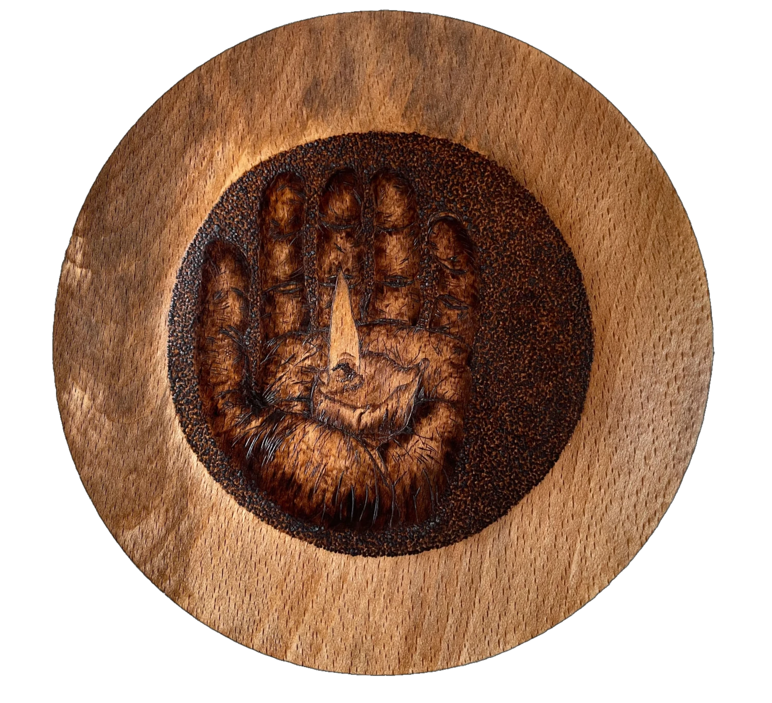 a large bowl with a hand holding a candle drawn in the centre using pyrography