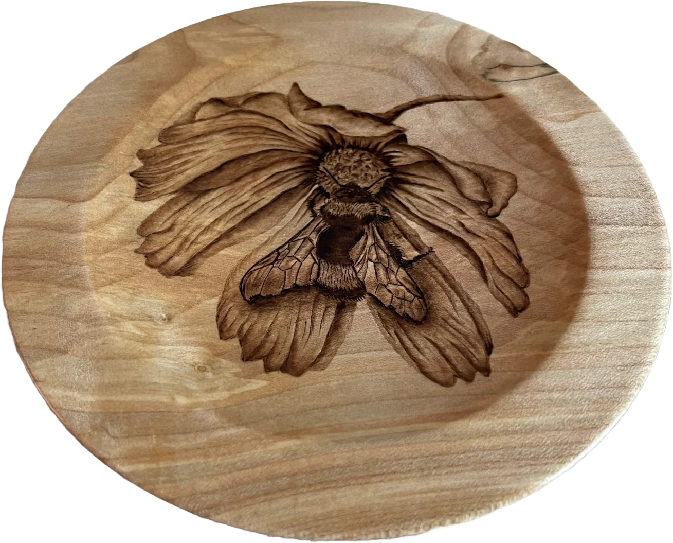 a medium sized bowl with a bee on a flower drawn in the centre using pyrography